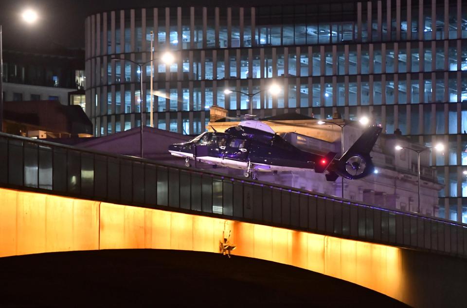  A chopper is pictured landing on London Bridge last night