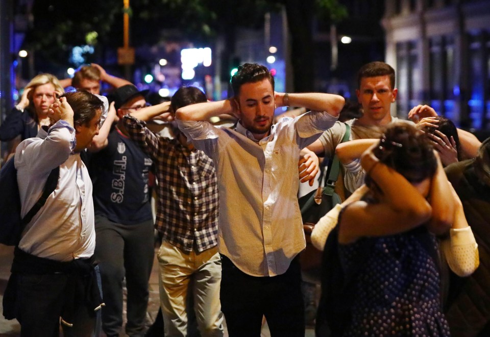 People being marched by police with their hands in the air, amid fears the terrorists could have been trying to mingle with them