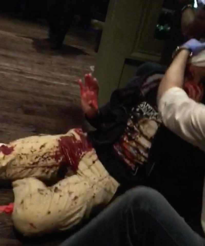  A victim of the attack lays on the floor of the pub as chaos erupts around them