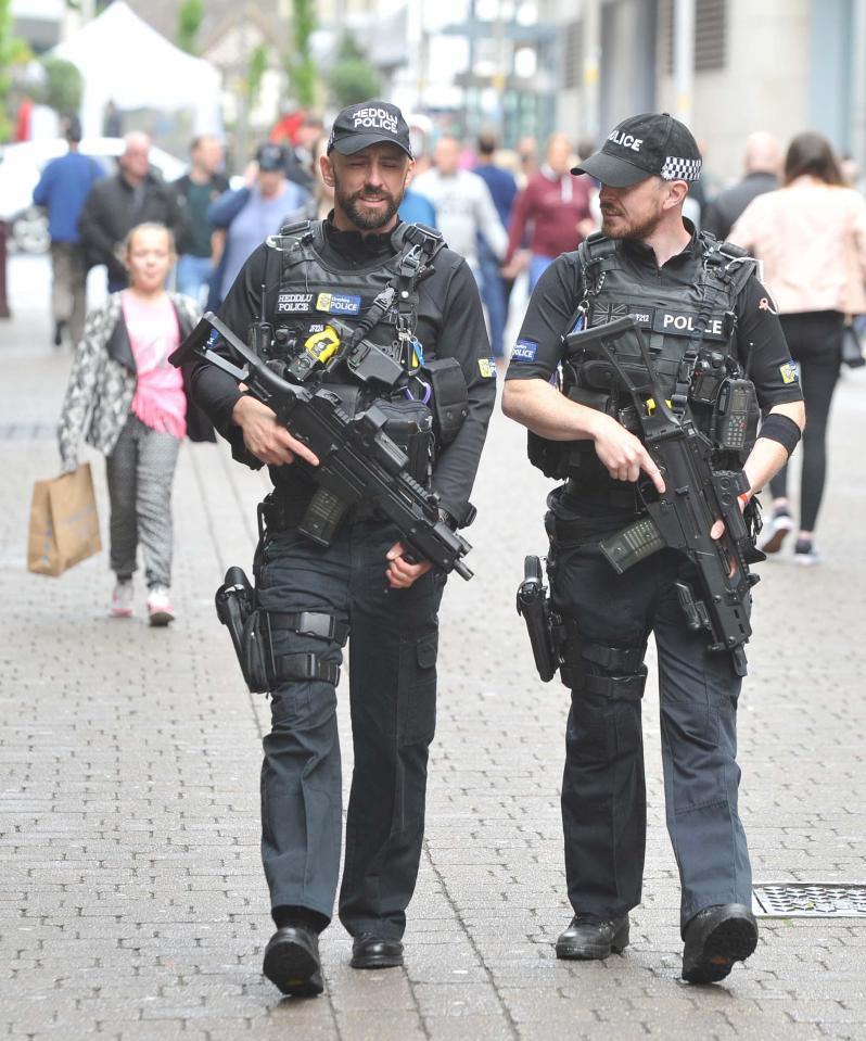  Armed police officers were pictured patrolling the streets to give reassurance to defiant fans