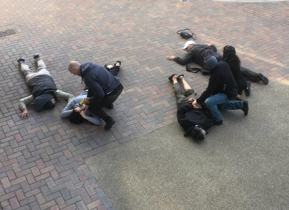  Officer with Taser pins two suspects to ground as colleague restrains two men and woman - one of whom is thought to have been arrested in terror ringleader Abz's Barking flat