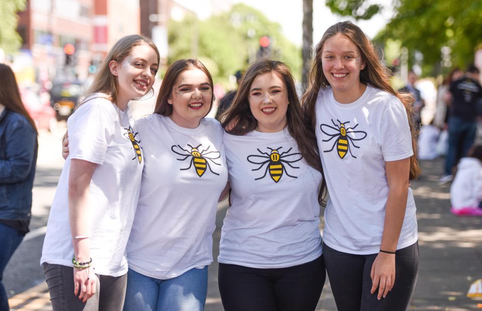  A group of friends pose in bumble bee t-shirts - a sign of solidarity with Manchester