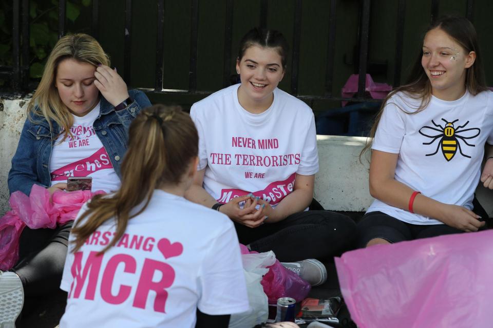  A smiling fan wears a t-shirt with the defiant slogan: "Never mind the terrorists - we are Manchester "