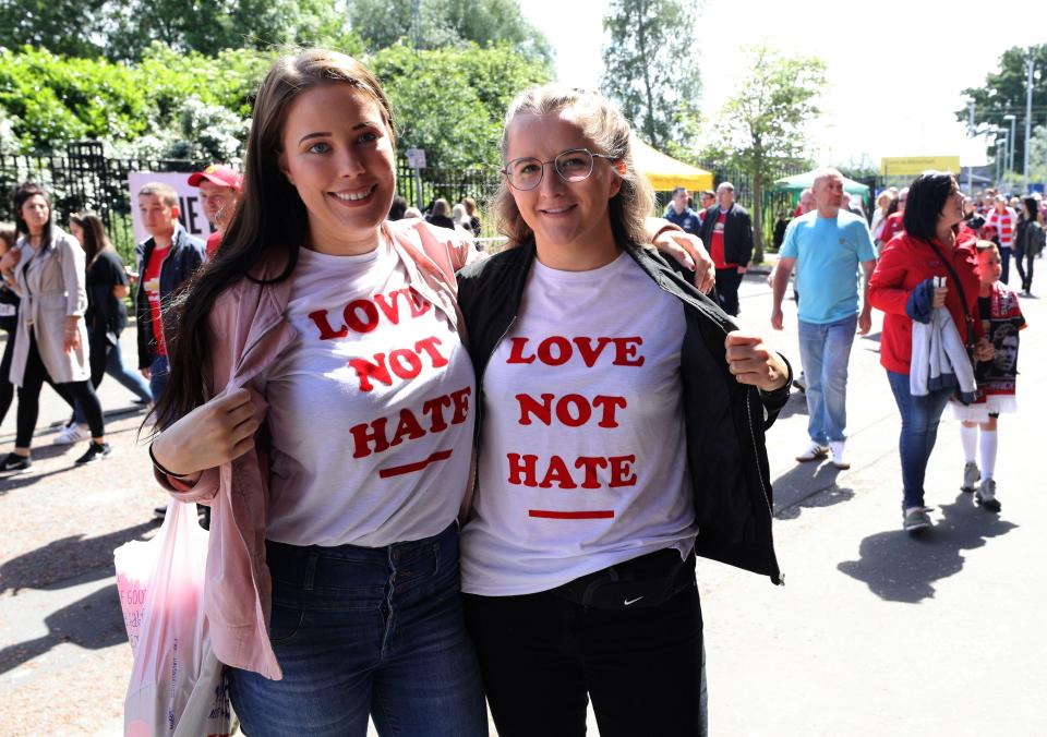  Two girls pose with 'Love not Hate' t-shirts ahead of the One Love Manchester tribute concert this evening