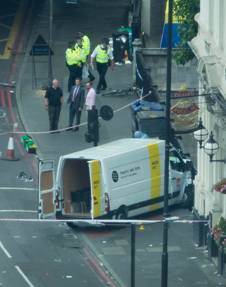 Police look over a rental van believed to have been driven by three men in an attack