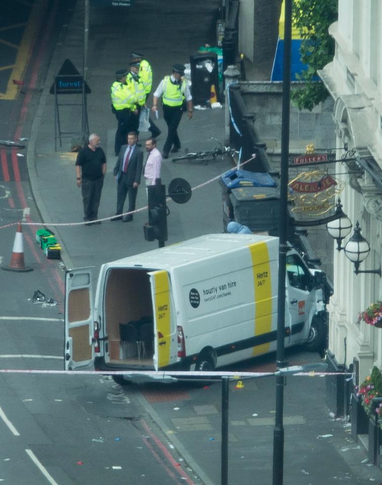  Police look over a rental van believed to have been driven by three men in an attack