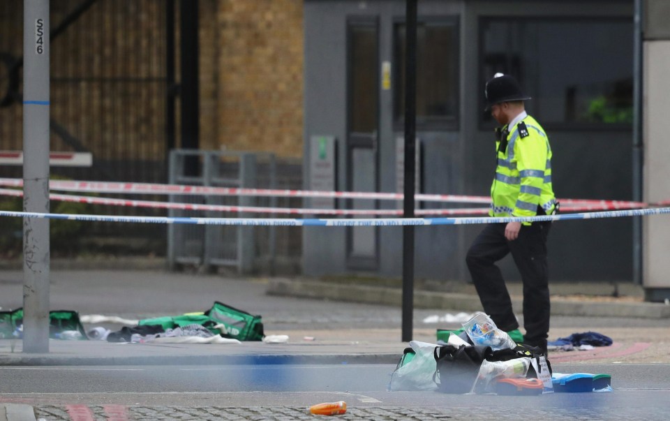 A police officer stands near first aid debris on Thrale Street