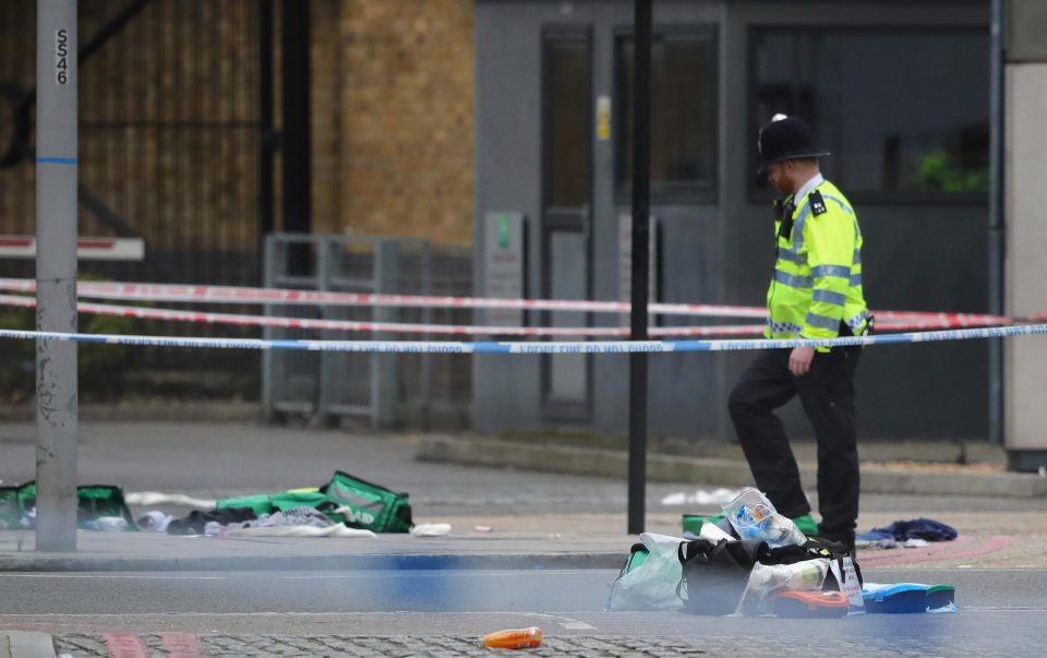  A police officer stands near first aid debris on Thrale Street