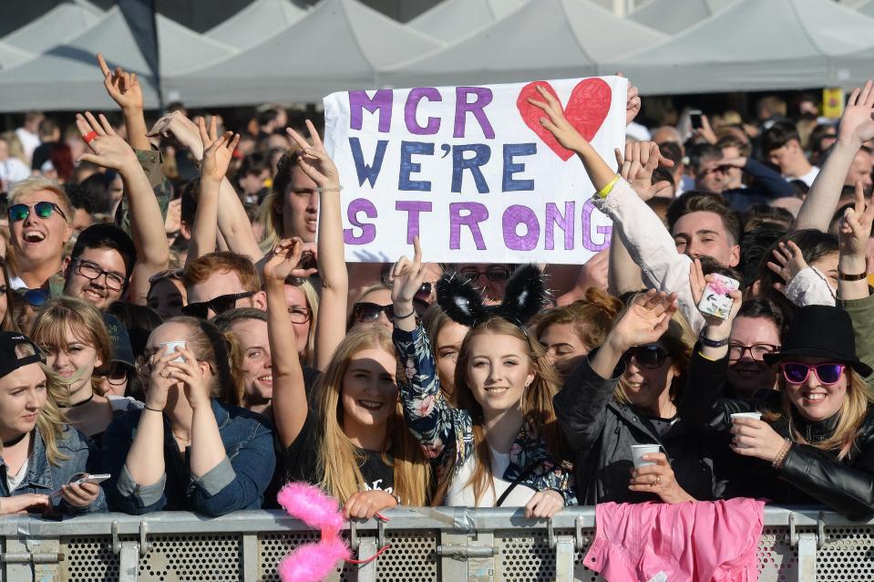  Defiant fans held up a sign which said 'Manchester we're strong' as they waited for the concert to begin