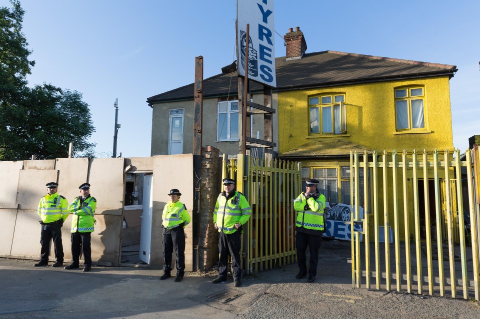 Cops outside a property raided in Dagenham this morning