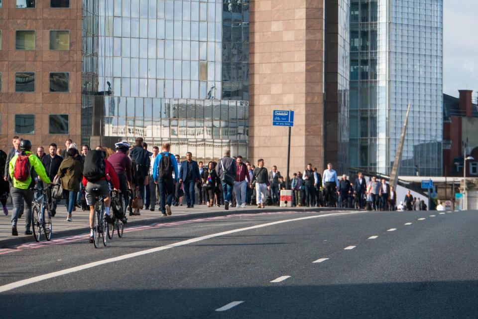  Londoners calmly walk over London Bridge as offices, shops and schools return to normal