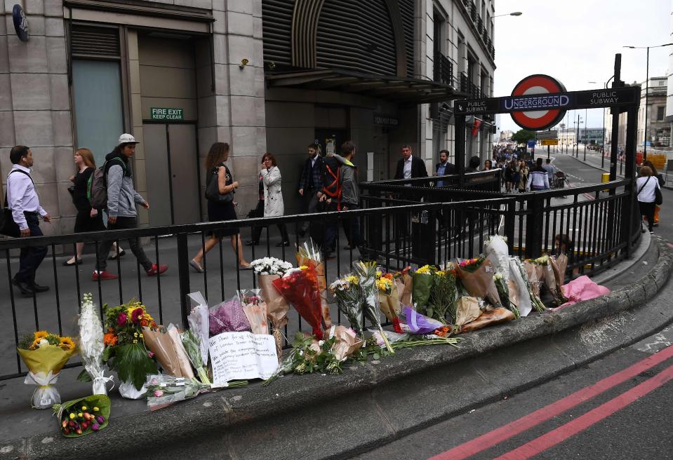  A row of flowers has been left at the entrance to Monument underground station, which is at the end of London Bridge