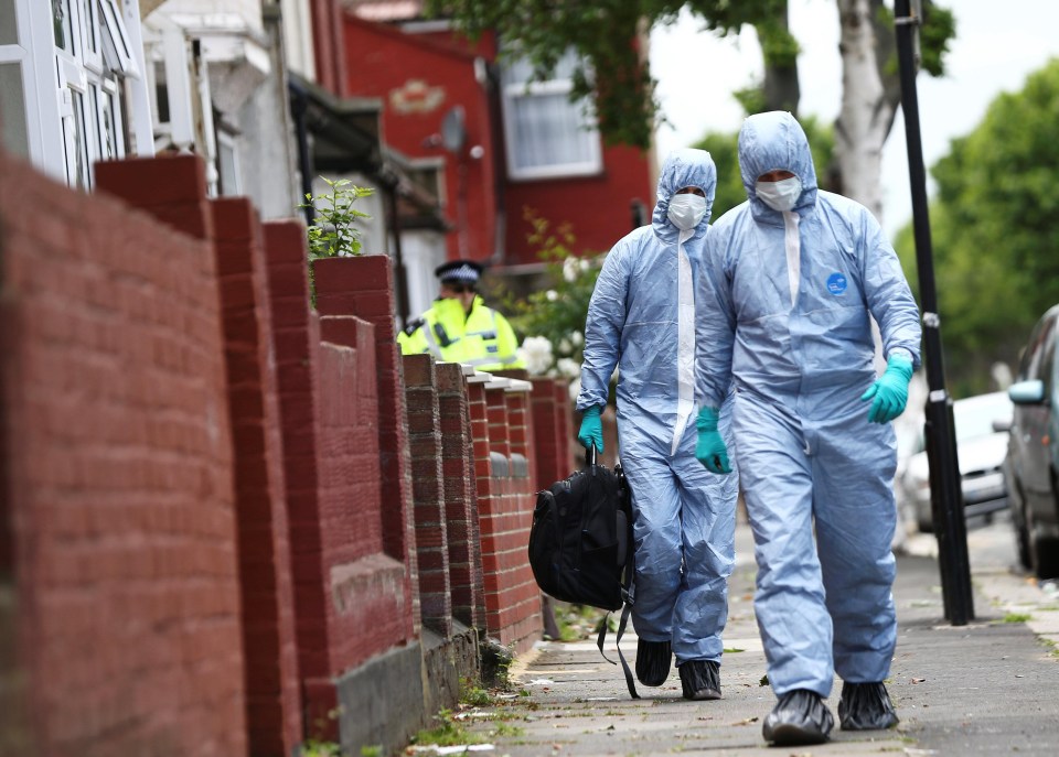 Forensic teams leave a raided property in East Ham