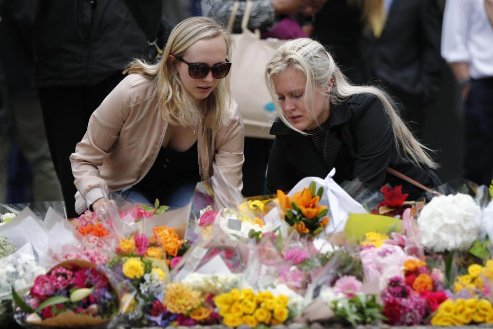  Office workers lay their tributes at makeshift shrines