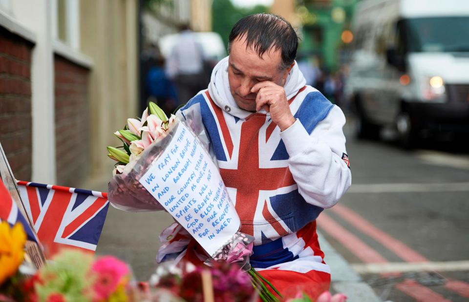  Patriotic passer-by lays flowers and sheds a tear