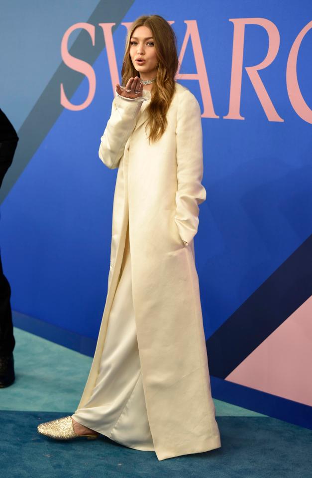  Gigi hid her figure under a long cream-coloured gown and a matching coat