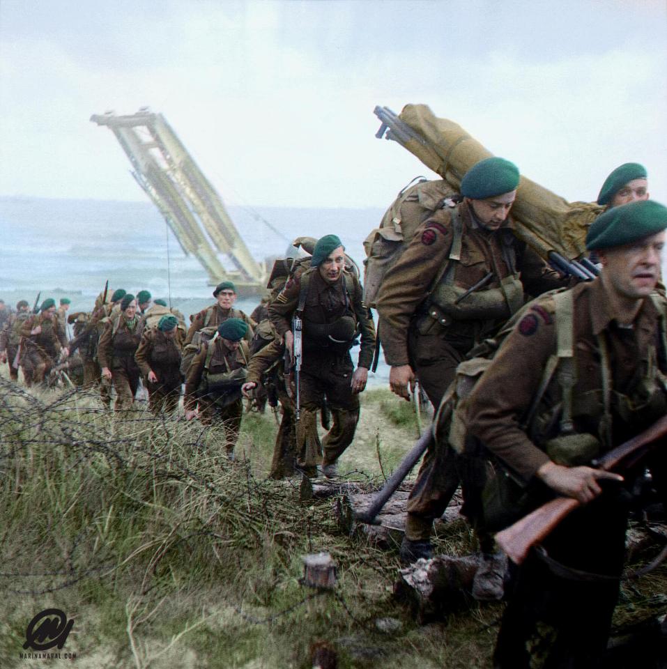  Royal Marine Commandos attached to 3rd Division move inland from Sword Beach on the Normandy coast. In the early hours of June 6, 1944, 20,000 British and American airborne soldiers descended by parachute and glider in the areas of Ranville and St Mère & Église in Normandy.