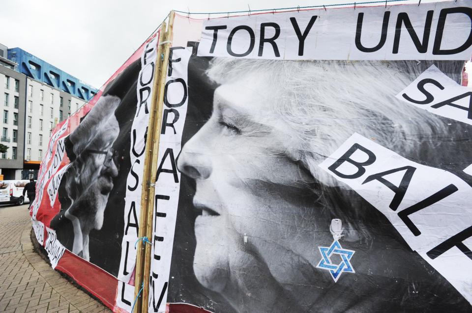  It shows Theresa May with a bright blue earring - in the shape of the star of David