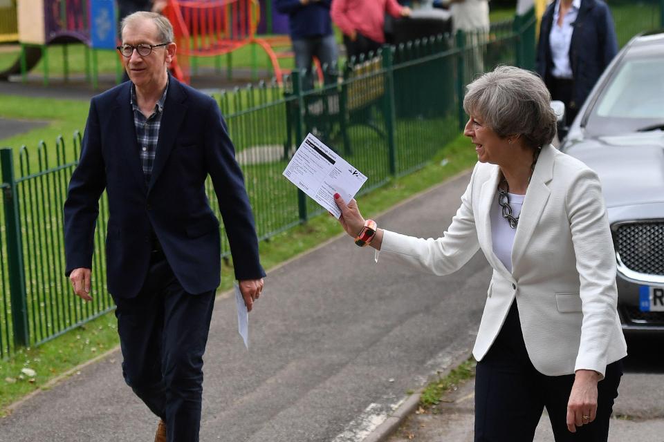  Got your ballot paper? Theresa votes with husband Philip this morning