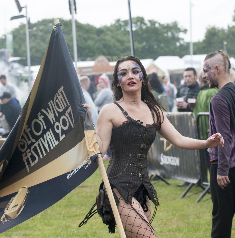  A woman dressed in a black corset and fishnet tights performs at the festival