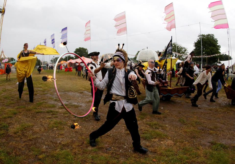  A fearless street artist walks through the festival performing with a flaming hoop