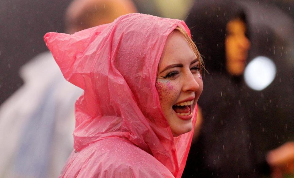  The rain didn't put this party-goer off as she was seen laughing through the rain in a vivid pink poncho