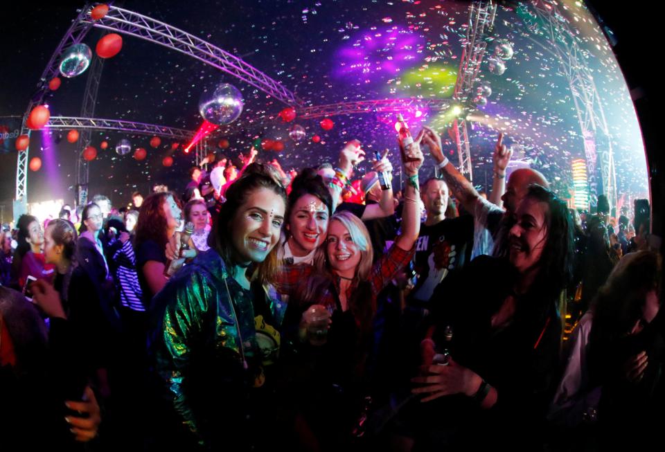  A group of friends take a break from dancing to smile for the camera in one of the festival's music tents