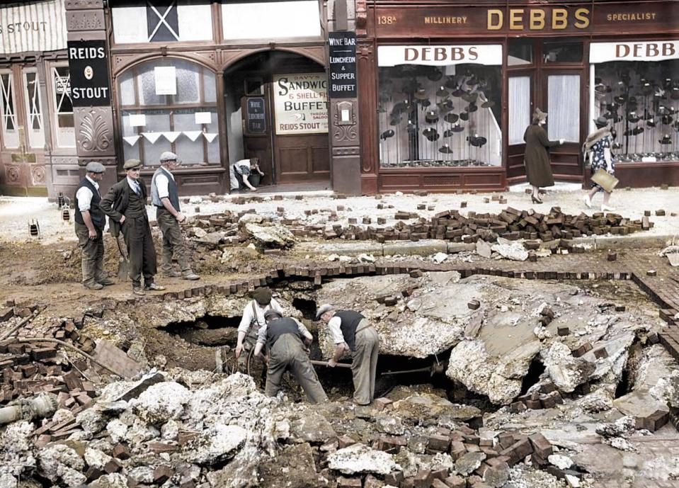  September 7, 1940: Men assess the damage following a night raid on Elephant & Castle. Civilians sheltered in the underground station as German bombs were dropped.