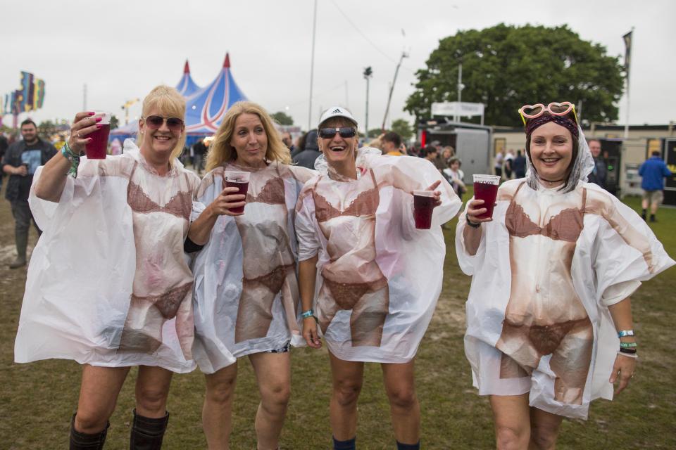  This group of festival-goers saw the funny side of the bad weather with these novelty cover-ups