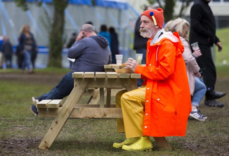  This man was certainly prepared for the rain in his bright orange rain jacket and luminous waterproof trousers