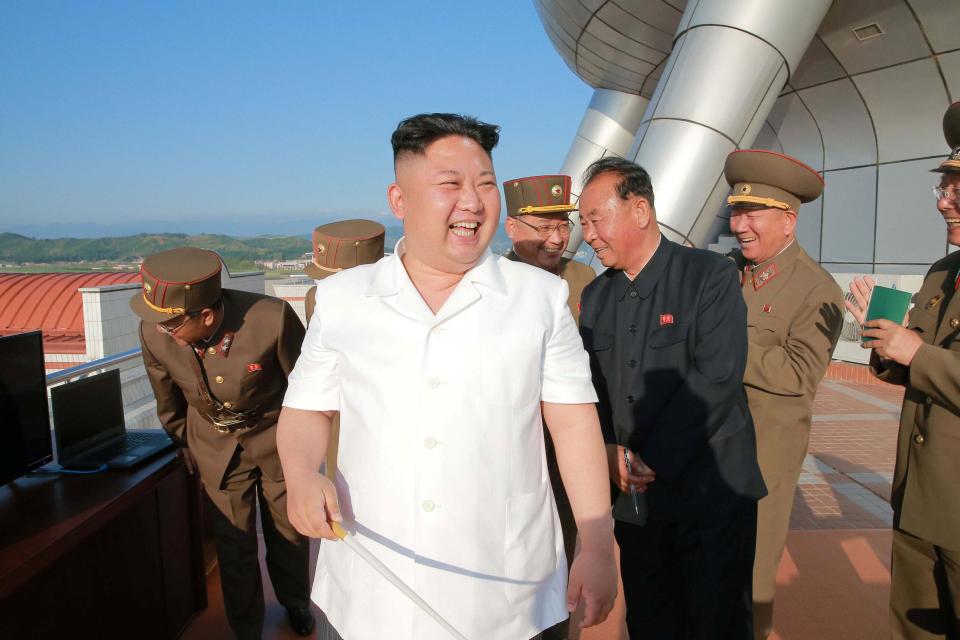  North Korean leader Kim Jong Un reacts after a test-fire of new cruise missile