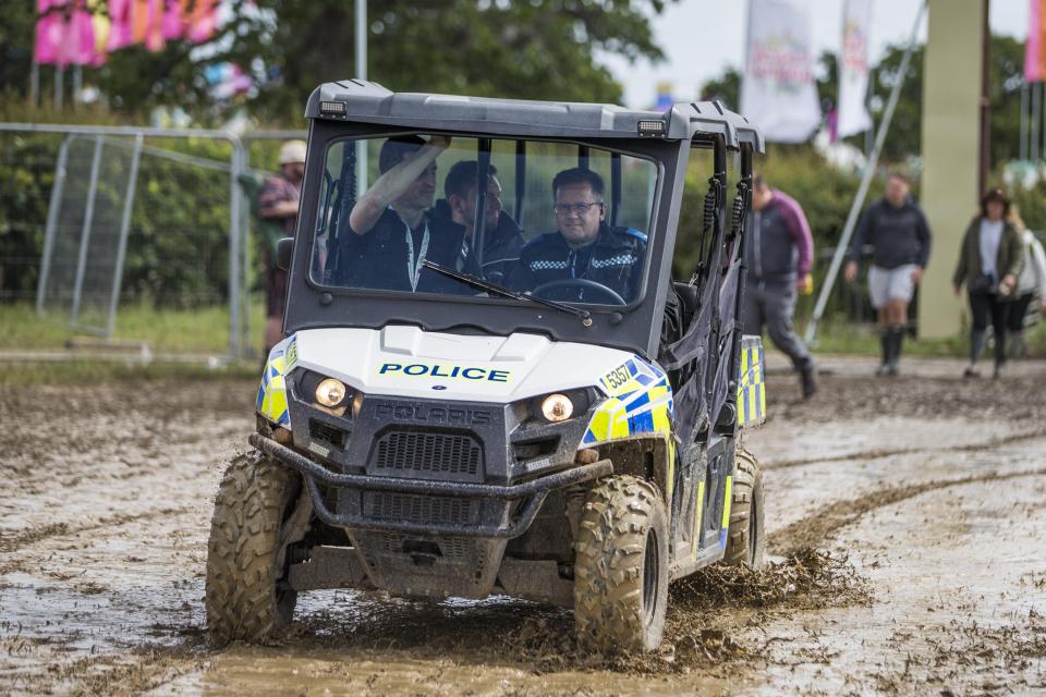  Police could be seen travelling around the extremely muddy site in buggies