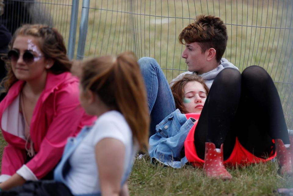  One festival-goer decided to take a nap on the grass, despite the mud