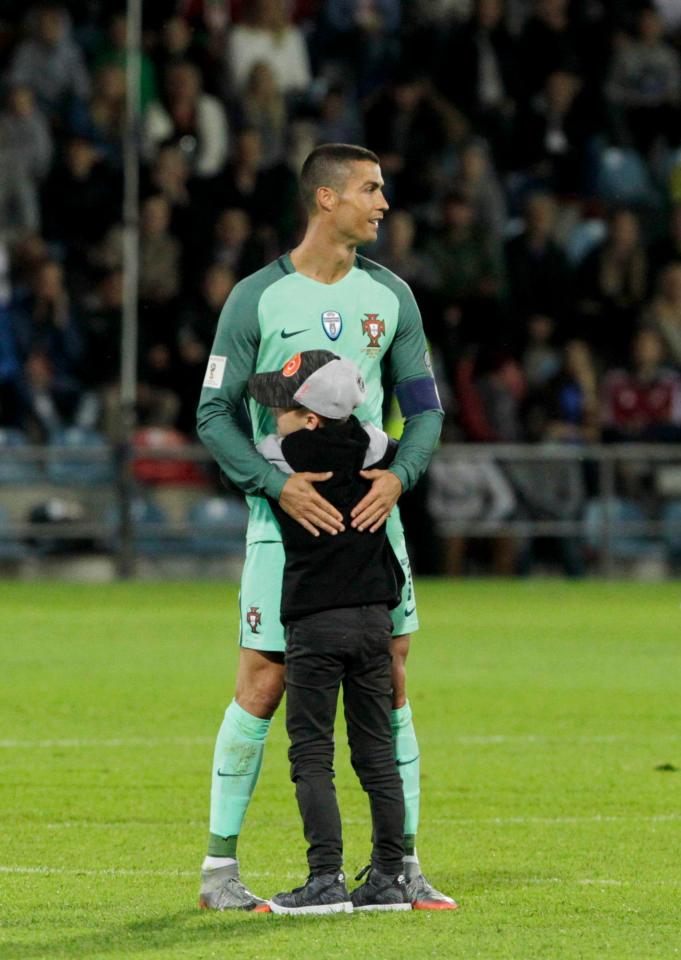  During Portugal's game with Latvia Ronaldo was hugged by a young pitch invader