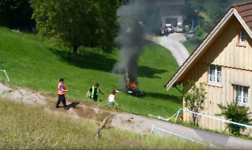  Onlookers watch the crashed car which Hammond escaped before it caught fire