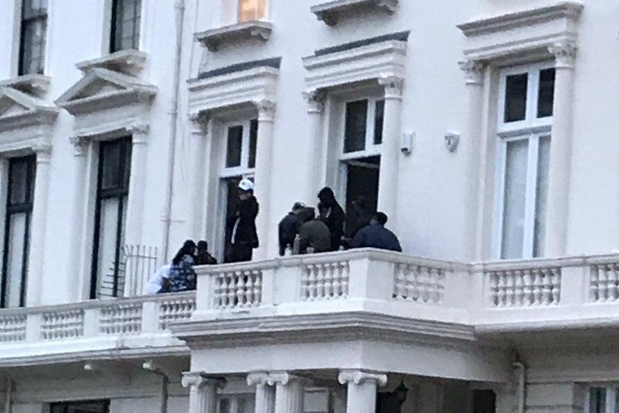 Revellers were seen spilling out onto the balcony of the posh London property