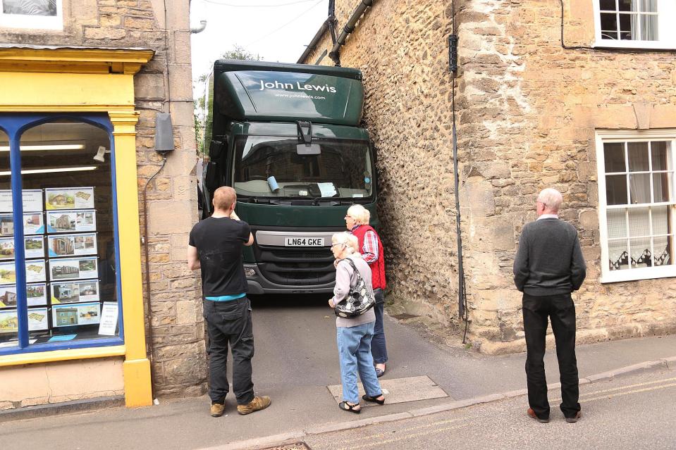  Locals in Bruton look on as John Lewis lorry is stuck down narrow lane