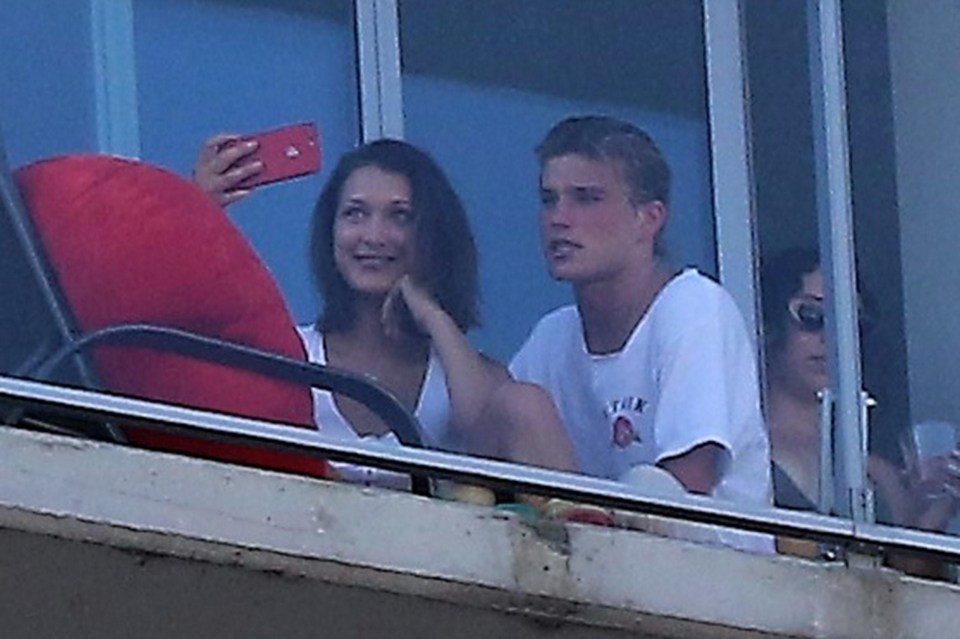 Bella posed for selfies with the male model on the apartment balcony