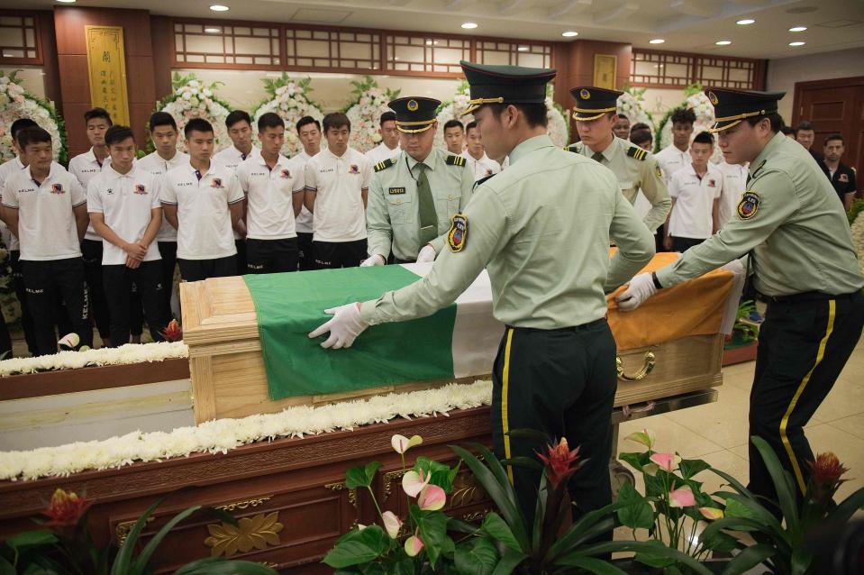  Players watch on as Tiote's coffin is moved onto a stand during the tearful occasion