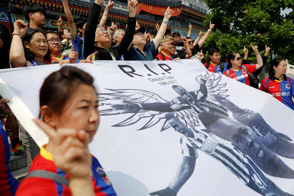  Fans with a tribute banner chanted his name outside the service venue