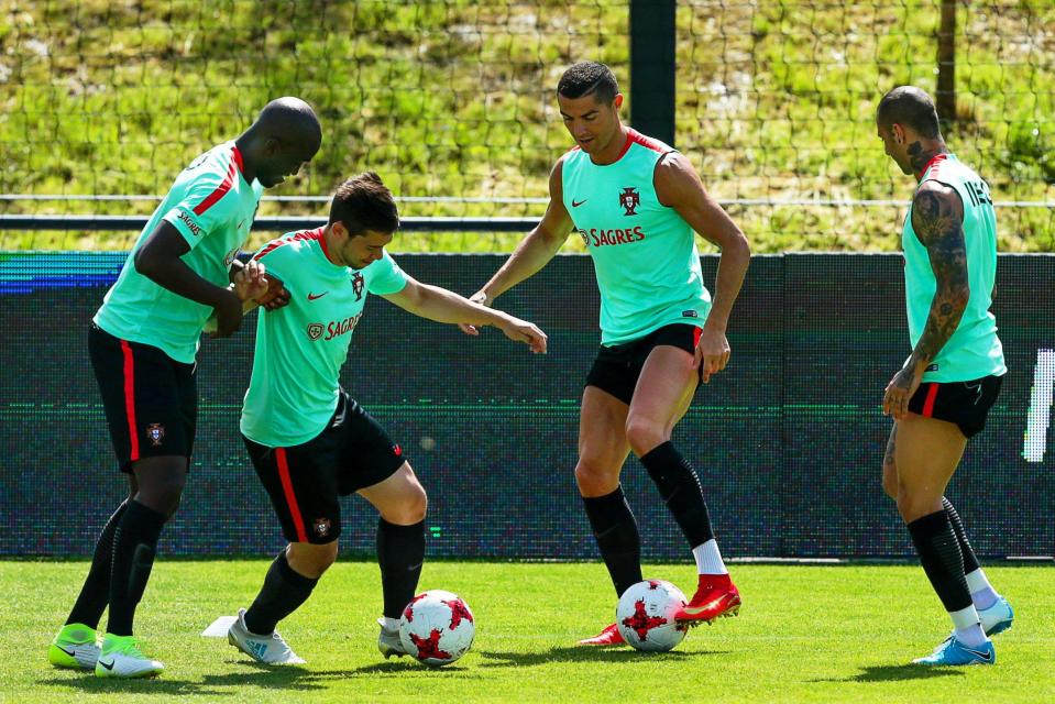  Cristiano Ronaldo gets stuck into some ball drills with the Portugal squad today despite tax row looming over him