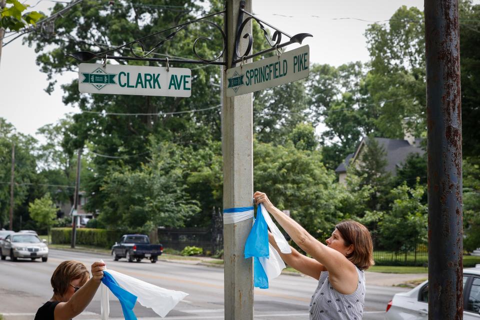  Residents put up blue and white ribbons near the family's home in a suburb of Cincinnati