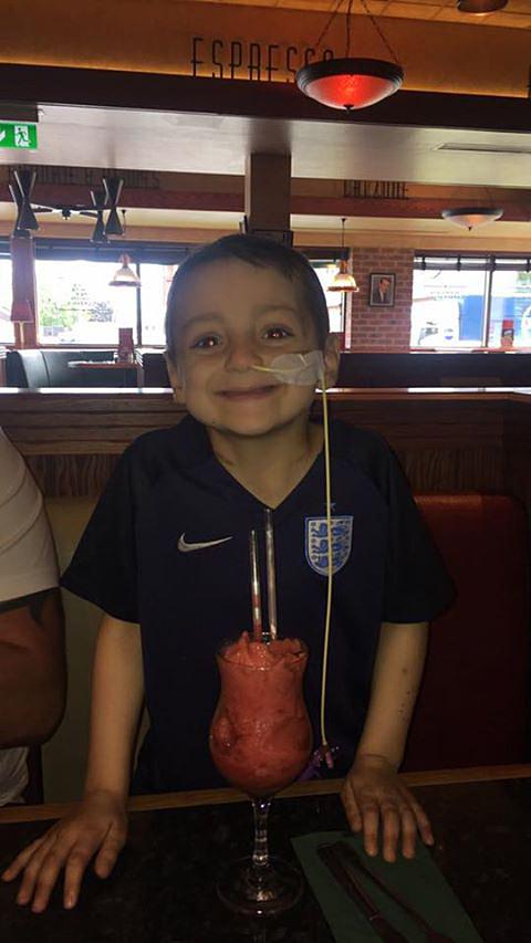 Brave Bradley beams as he enjoys a mocktail during a restaurant visit