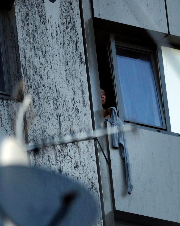 A person could be seen peering out of a window of the burning building in the early hours of this morning