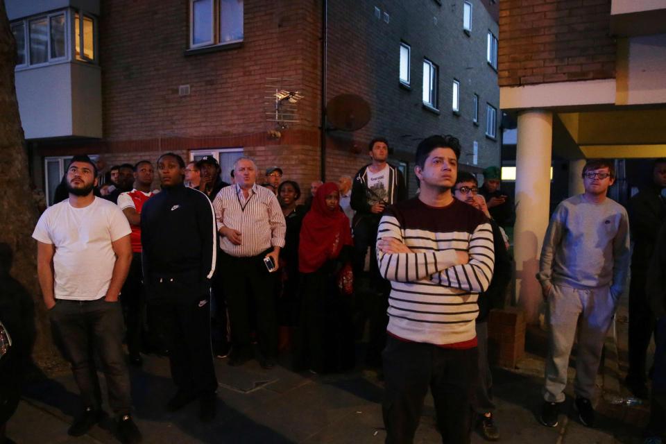  Locals watch on as the fire grips the tower block in west London