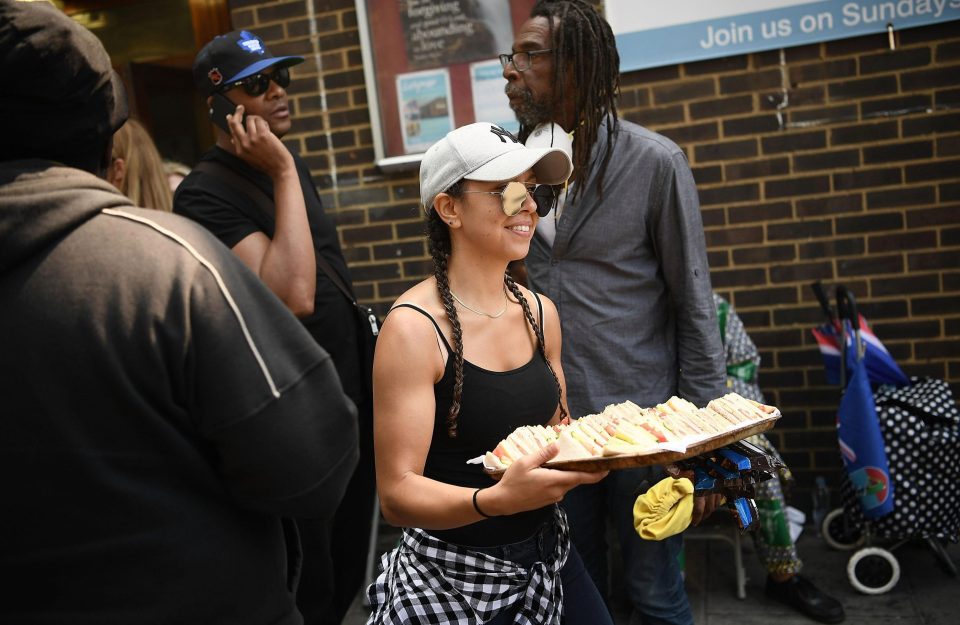  Kind woman hands out sandwiches to survivors after they were left homeless