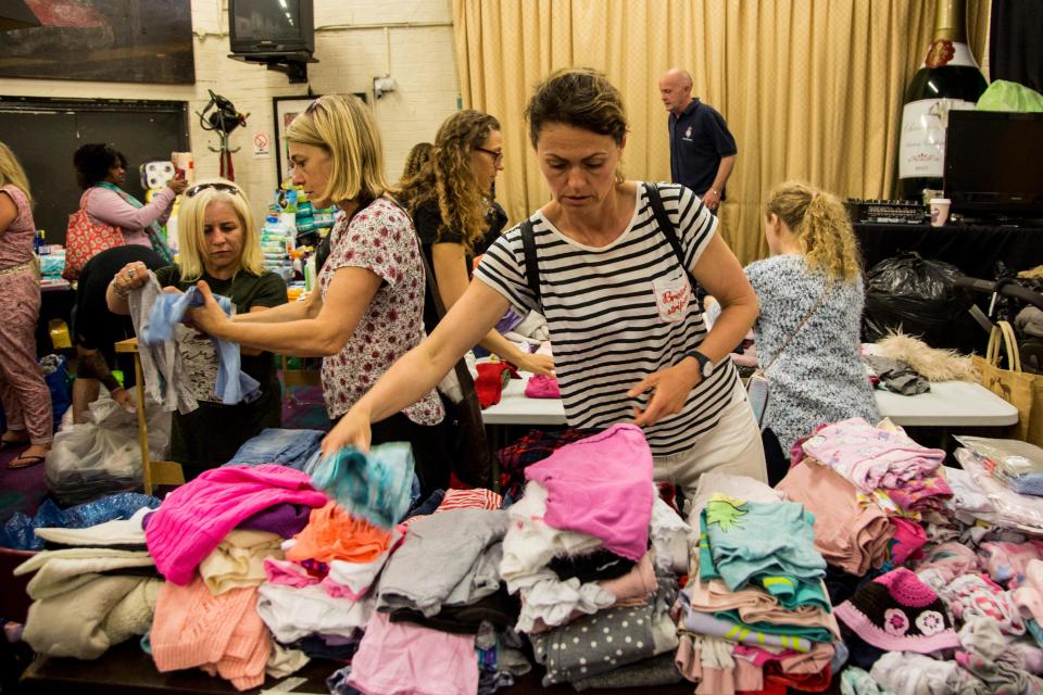  Residents help out at the Maxilla Social Club where food and clothes donations are being sorted