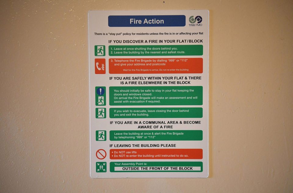  A fire action sign inside a block near Grenfell advises residents to 'stay put' if the fire is not in their flat