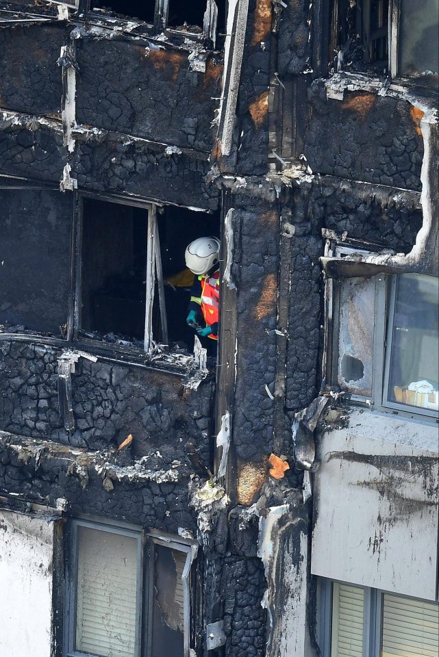  A firefighter assesses the damage in the aftermath of the Grenfell blaze