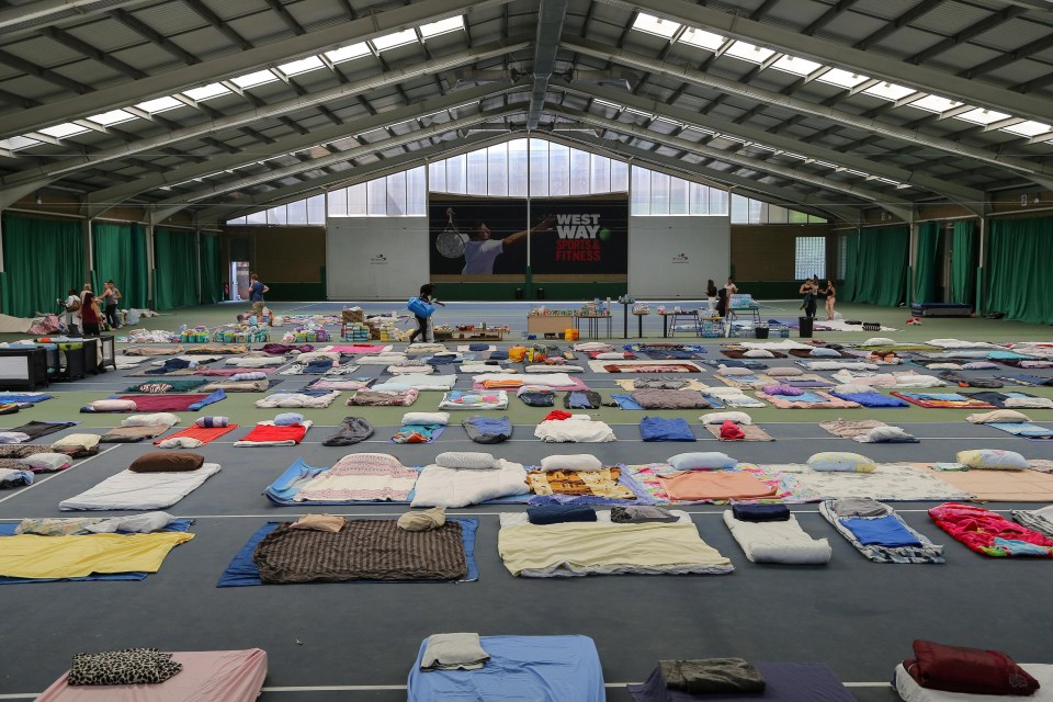 Evacuated residents spend the night at Westway Sports Centre on gymnastic mats